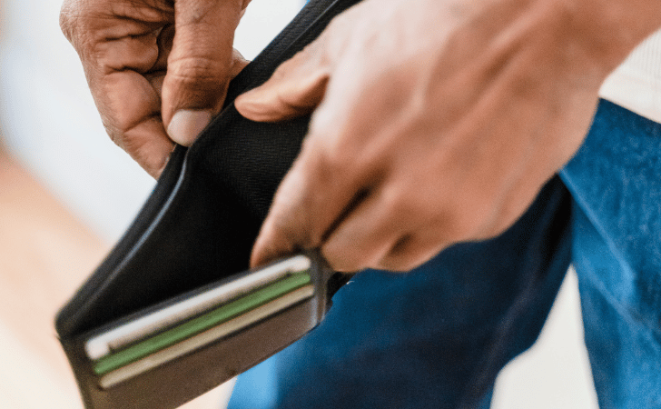 close up of man with hands inside an empty wallet