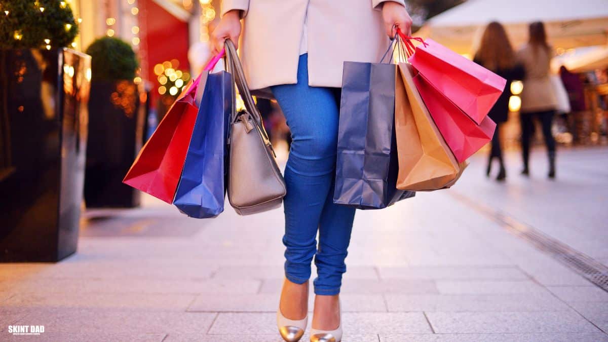 A woman walking down a British high street holding shopping bags, representing a simple mystery shopping trip.