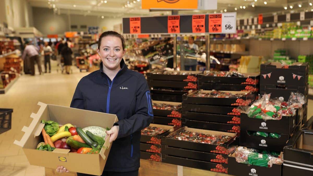 Lidl worker holding a Waste Not box