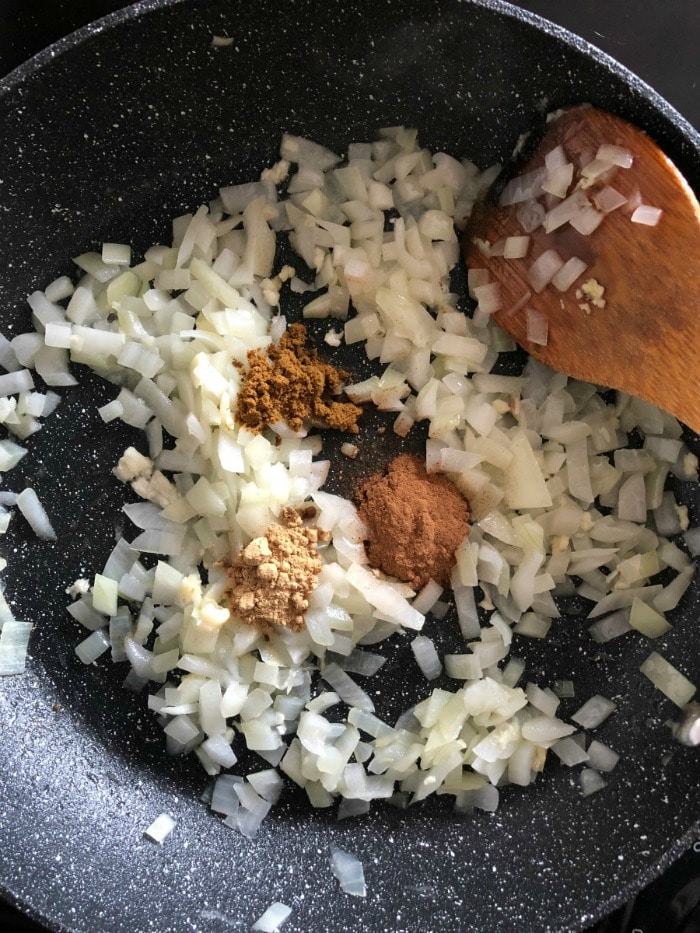 cooking onions and spices for lamb pie