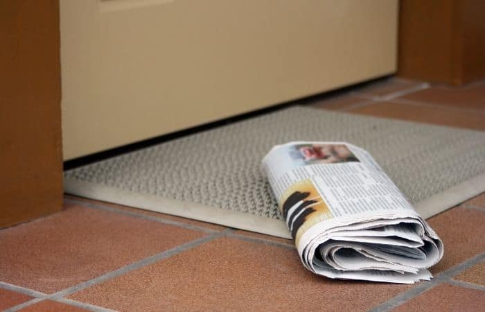 newspaper on a doormat