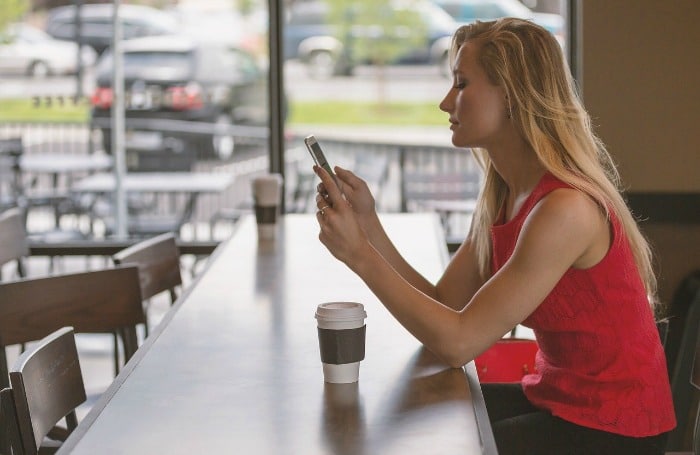 woman on phone in cafe