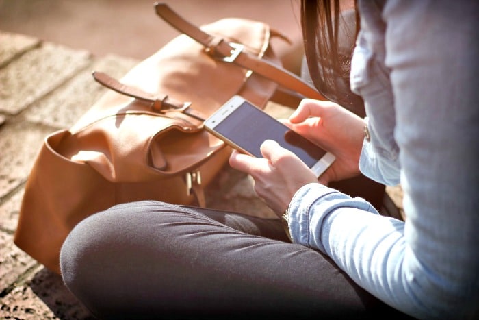 woman sitting using phone