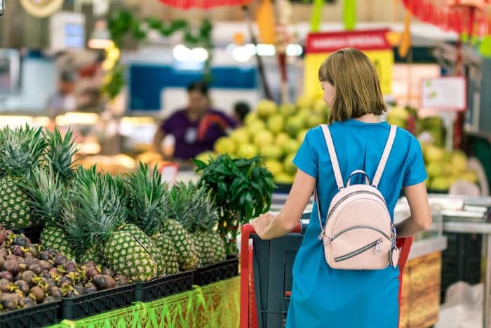 woman shopping in fruit and veg aisle