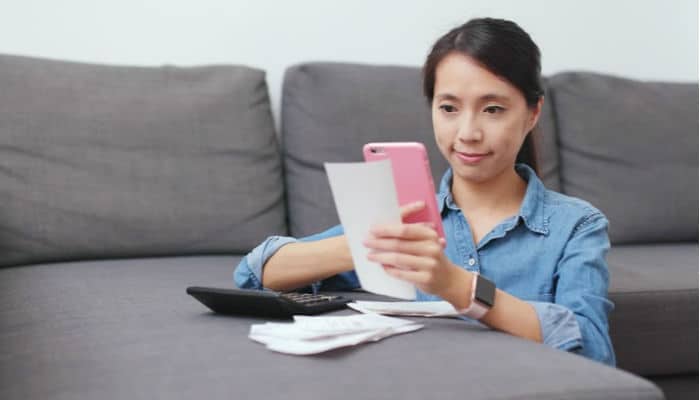 woman taking a photo of receipt