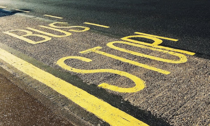 bus stop sign on road