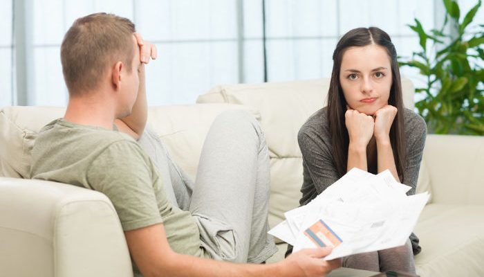 worried couple doing their accounts at home
