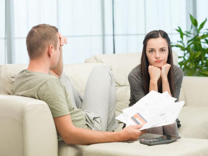 worried couple doing their accounts at home