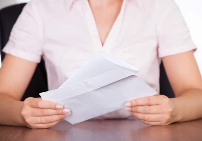 woman opening letter