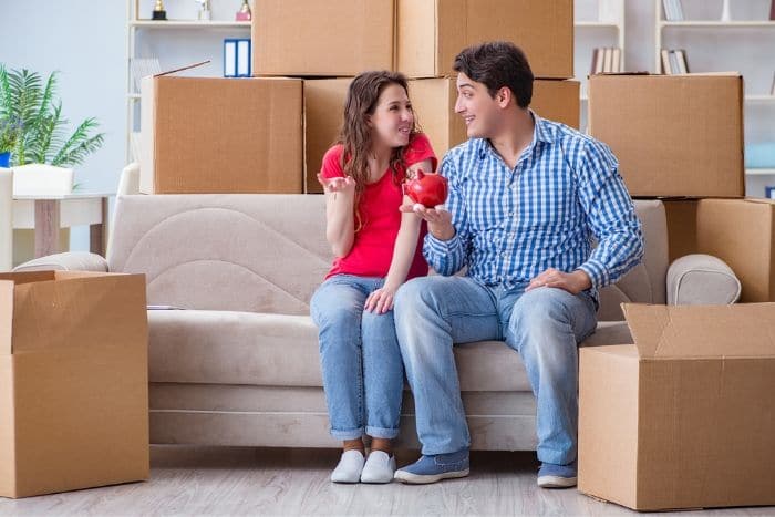 Young pair moving in to new house with boxes