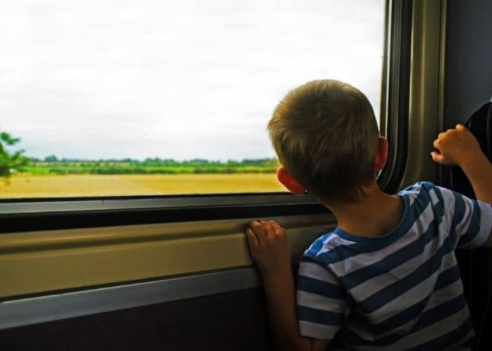 young boy travelling by train