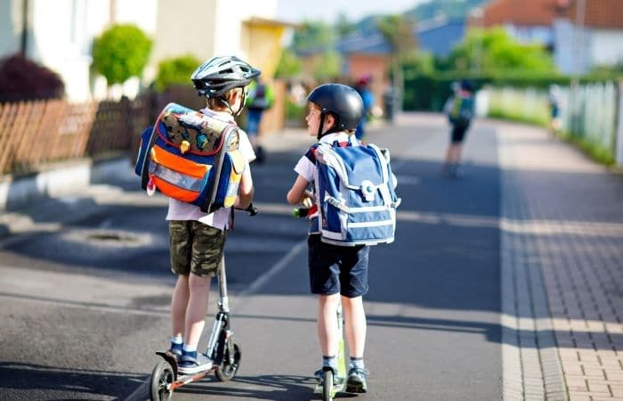 children riding scooters