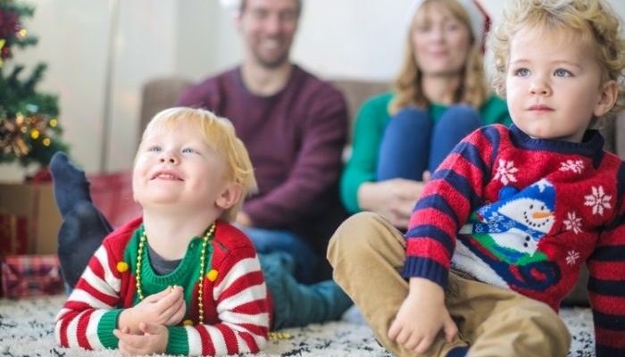 young family watching TV at Christmas
