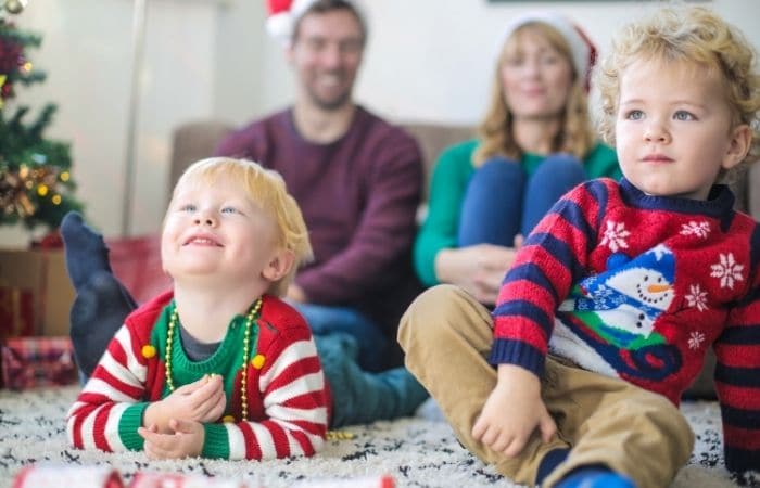 young family watching TV at Christmas