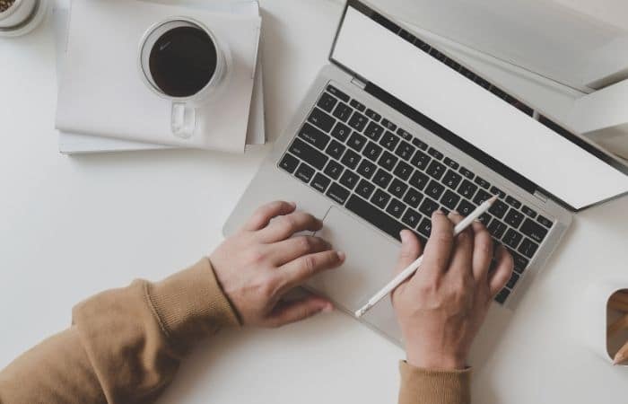 A person typing on their laptop