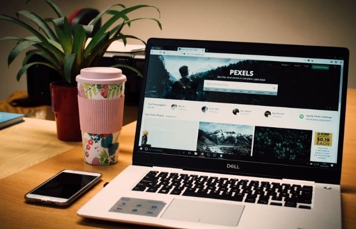 coffee cup next to laptop