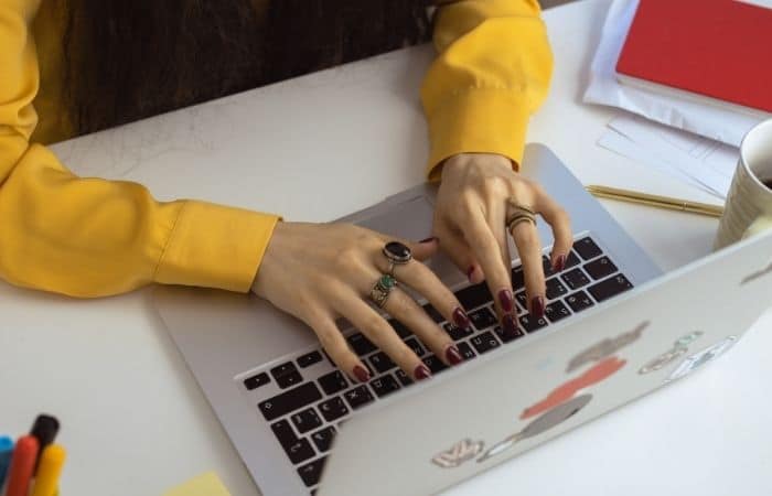 woman writing on a laptop