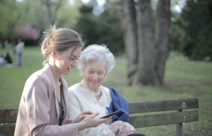 young and old woman looking at phone