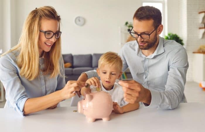 young family saving with piggy bank