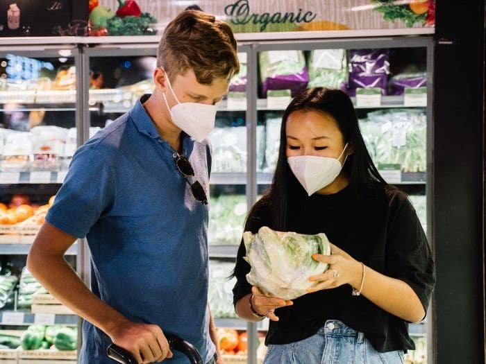 couple wearing face masks in supermarket