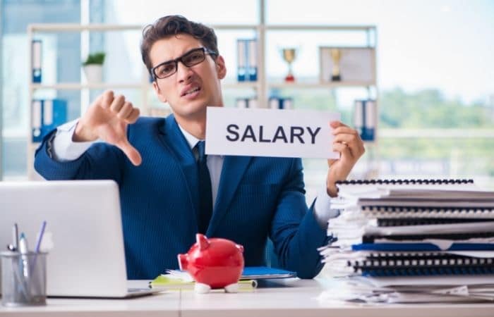 man with thumb down holding paper that says salary