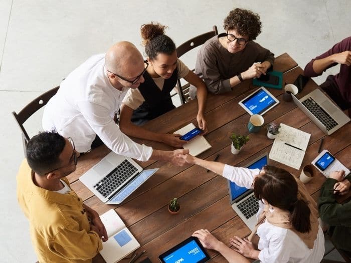 team at work shaking hands over a table