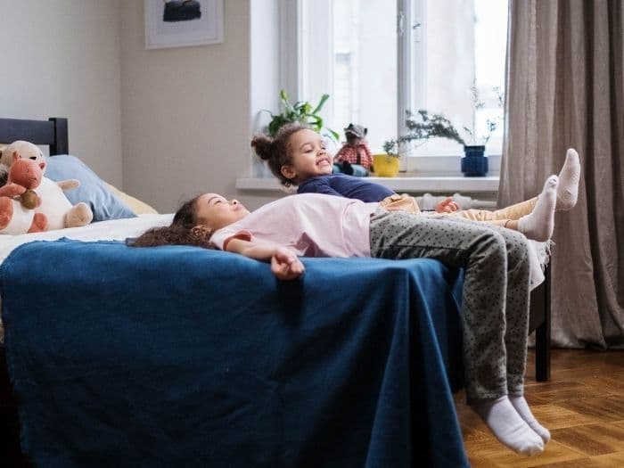 children playing on a bed