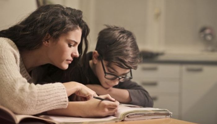 woman doing homework with a child