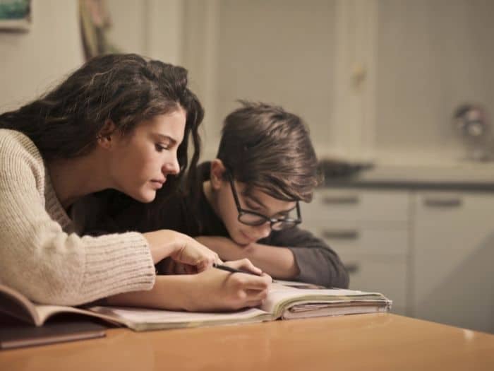 woman doing homework with a child