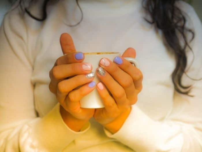 woman's hands holding a mug