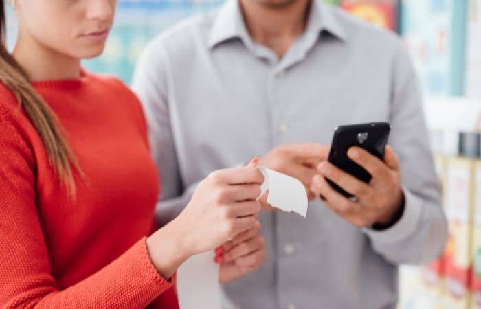 couple with receipt and phone