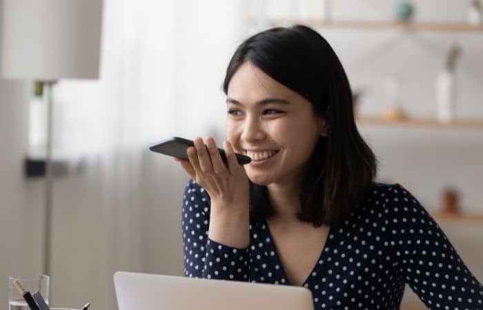 smiling woman talking on a phone using handsfree