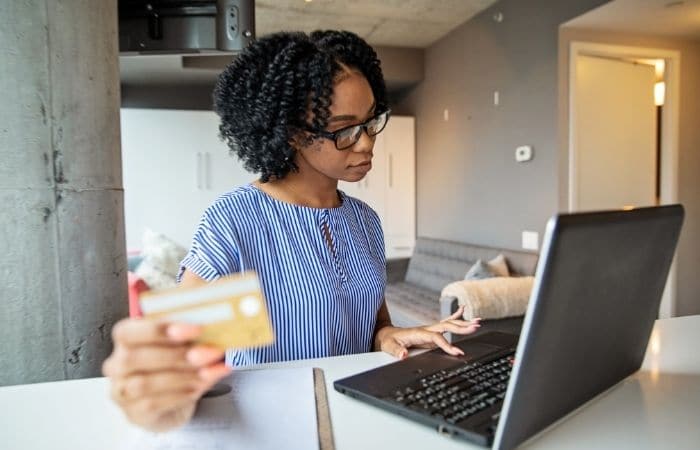 woman checking credit score on laptop