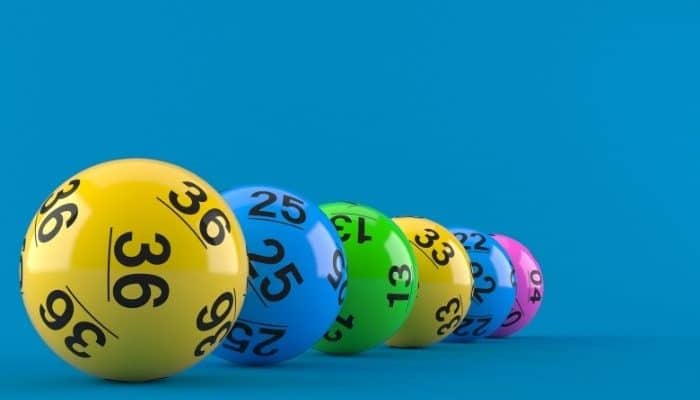 Brightly coloured lottery balls in a row on a blue background