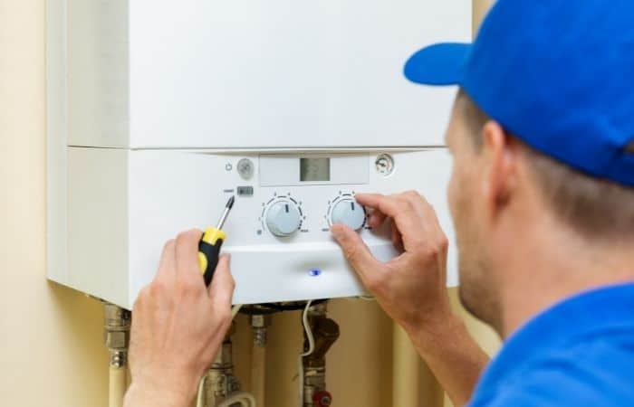 engineer adjusting boiler