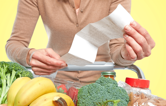 woman holding receipt over shop