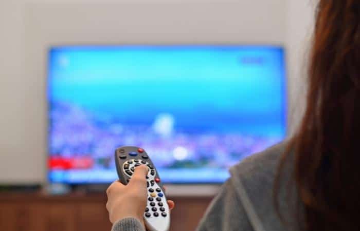 woman holding remote control