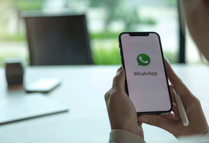 hands holding phone with whatsapp open