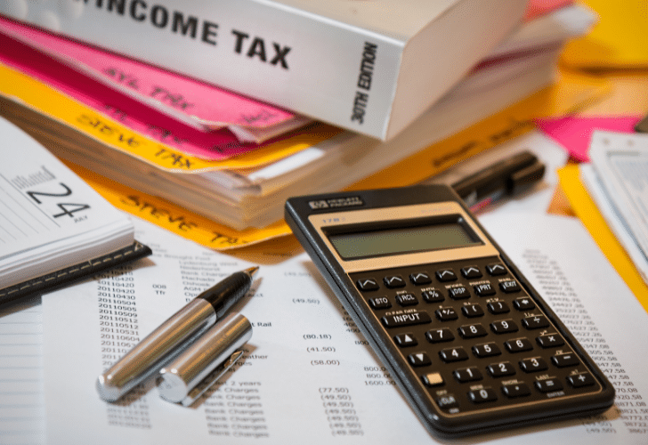 income tax book and calculator on top of paperwork