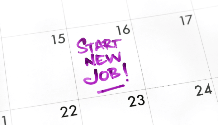 The words "start new job!" written in capitals in purple ink on a calendar