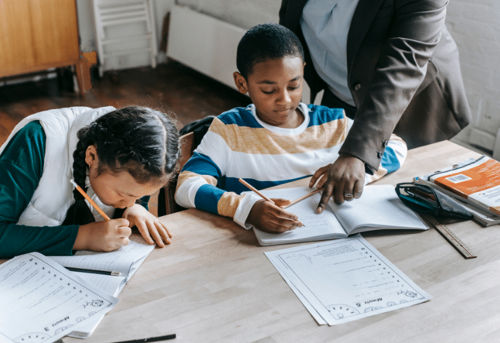 private tutor teaching two young boys