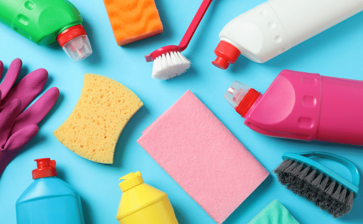 cleaning products and sponges on a blue background
