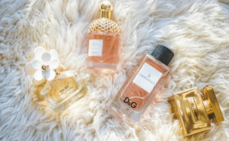 bottles of eau de parfum on a sheepskin rug