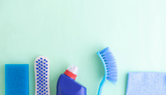 cleaning products and tools on a green surface