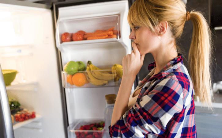 woman looking in fridge