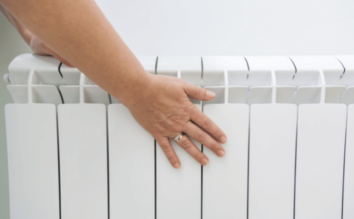 hand touching radiator