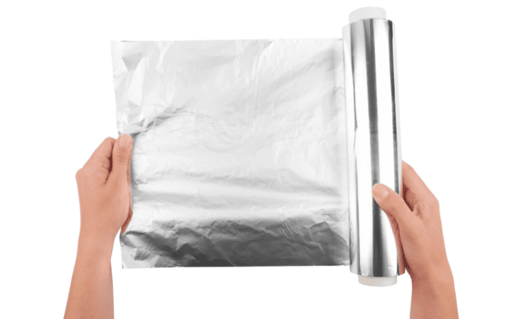 holding a roll of tin foil