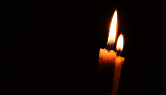 two candles in a dark room