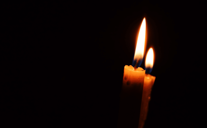 two candles in a dark room