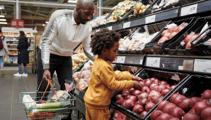 father and child shopping for vegetables in Sainsbury's